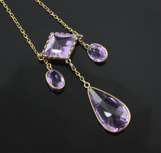 An early 20th century gold and shaped cut amethyst drop necklace, overall 52cm.